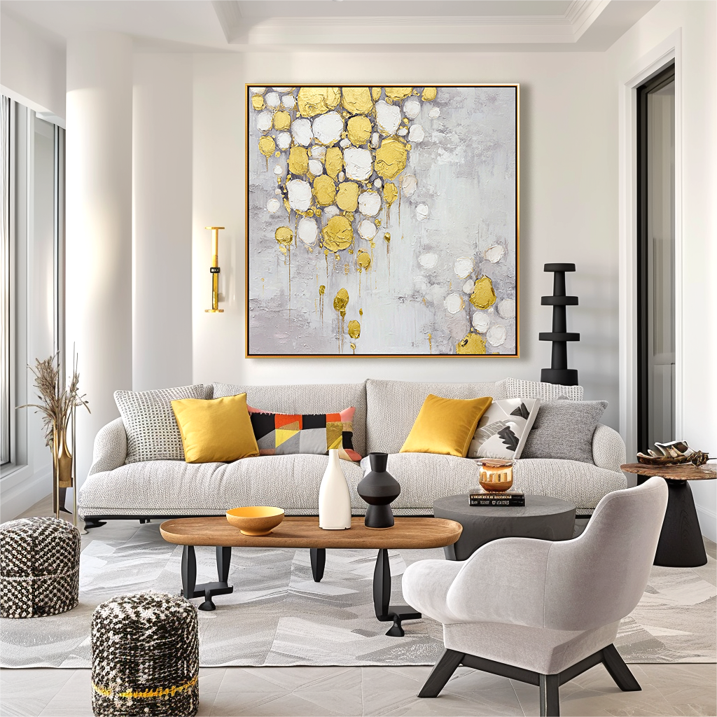 Abstract painting with gold and white textured drops on a soft gray background